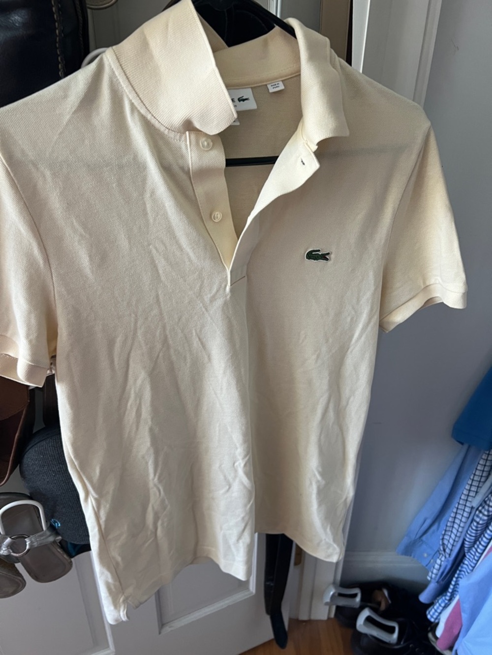 Lacoste Polo Shirt in Cream w/ Crocodile Logo 27” hem 2top 
P to p. 19”.